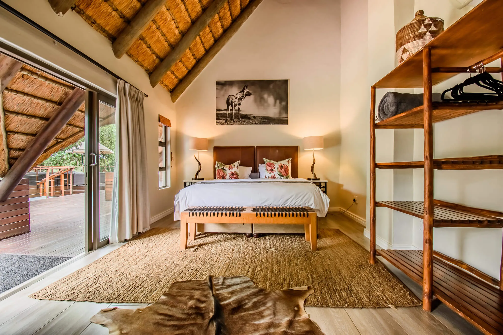 Cozy bedroom with wooden bed animal print rug and open sliding door
