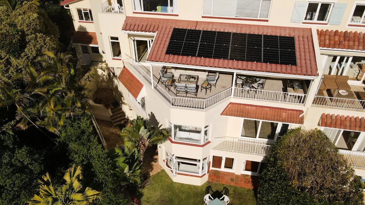 Aerial view of a house with solar panels on the roof