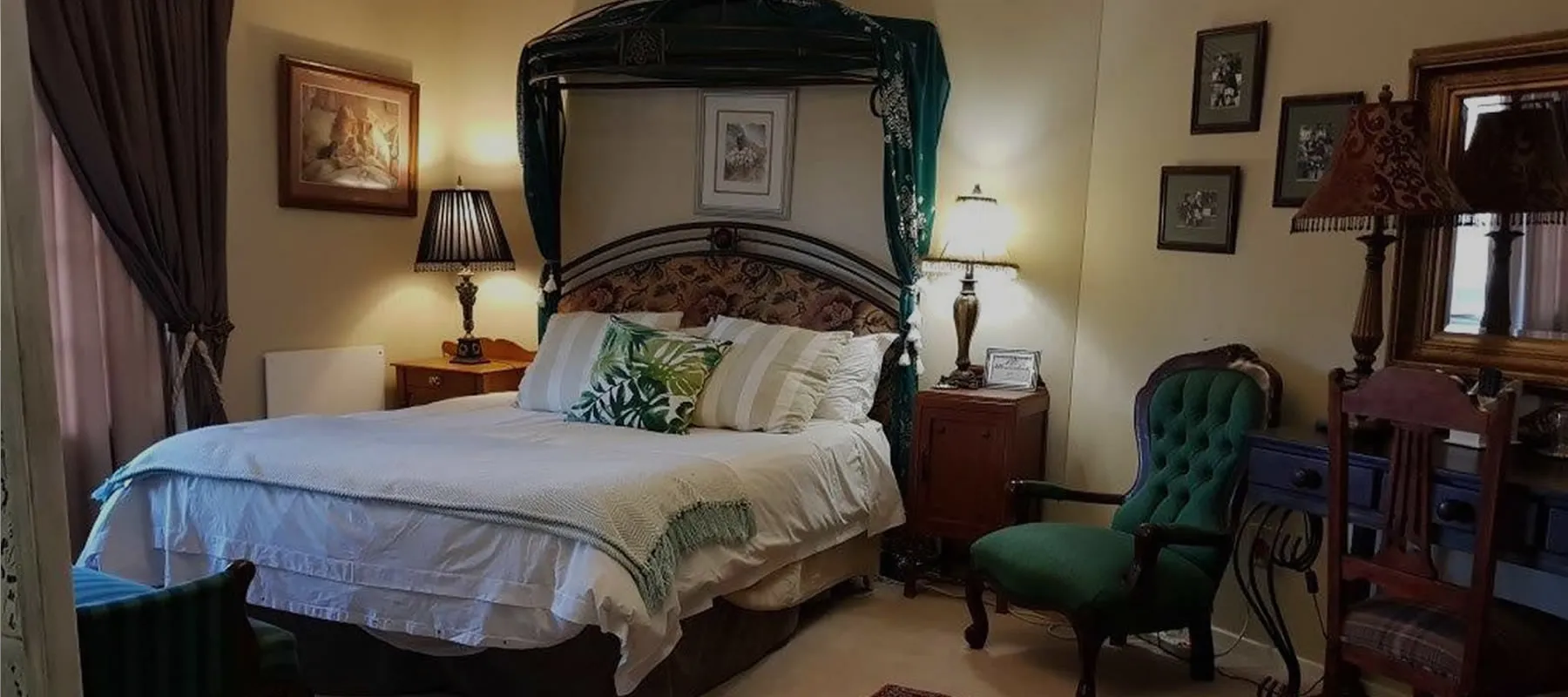 Cozy bedroom with a large bed green armchair and vintage decor