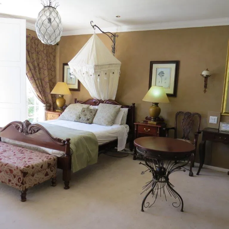 Fourposter bed with canopy in a cozy vintagestyle bedroom with wooden furniture