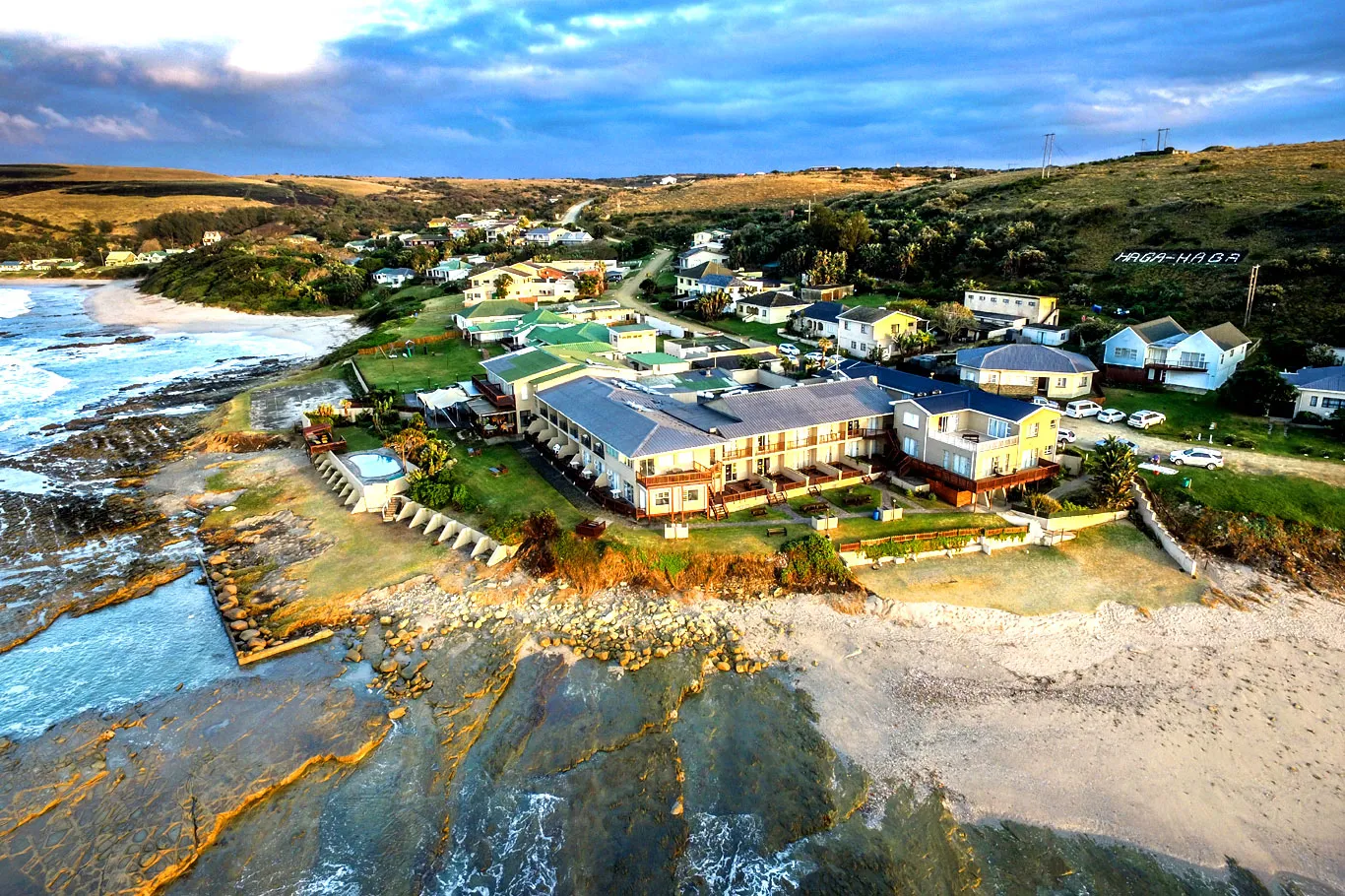 Aerial view of coastal town with buildings and sandy beach