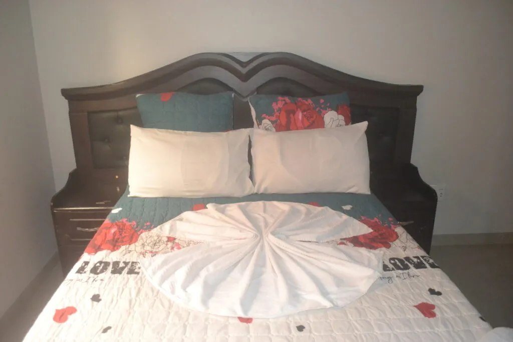A neatly made bed with decorative pillows in a bedroom