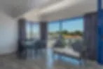 Blurred modern living room with large windows and outdoor view