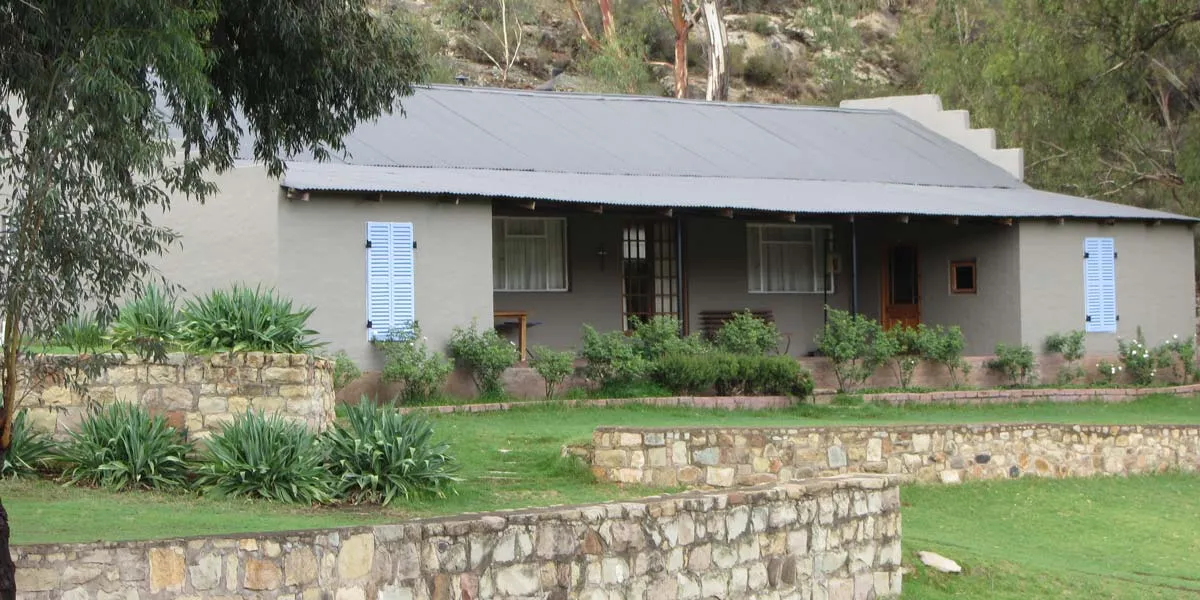 Singlestory house with stone walls and garden in a natural setting