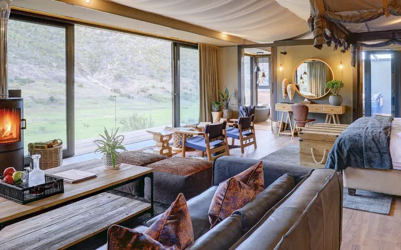 Cozy living room with large windows fireplace and outdoor view