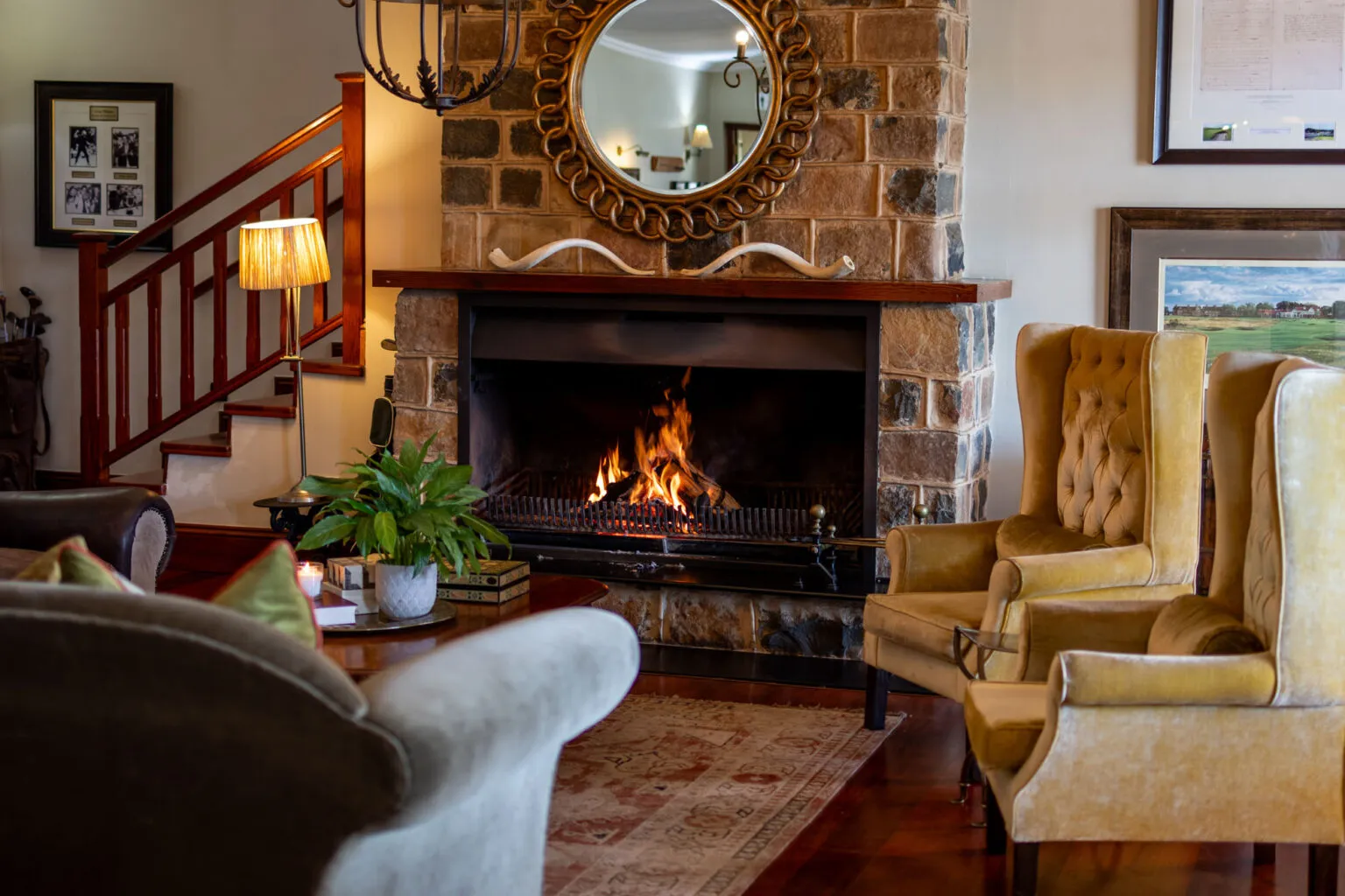 Cozy living room with fireplace armchairs and a mirror above the mantel
