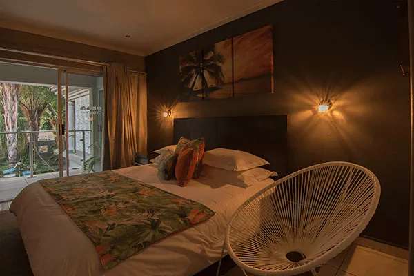 Cozy bedroom with a large bed tropical decor and sliding door to a patio