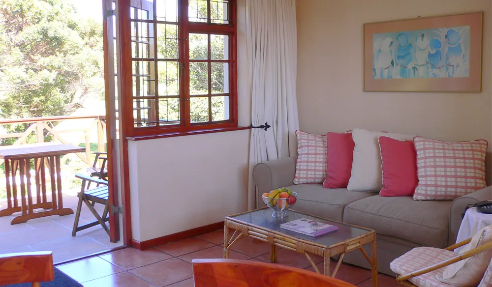Cozy living room with sofa coffee table and open door to outdoor area