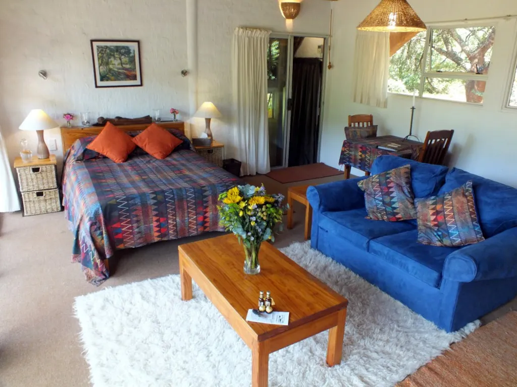 Cozy bedroom with a bed sofa coffee table and warm lighting