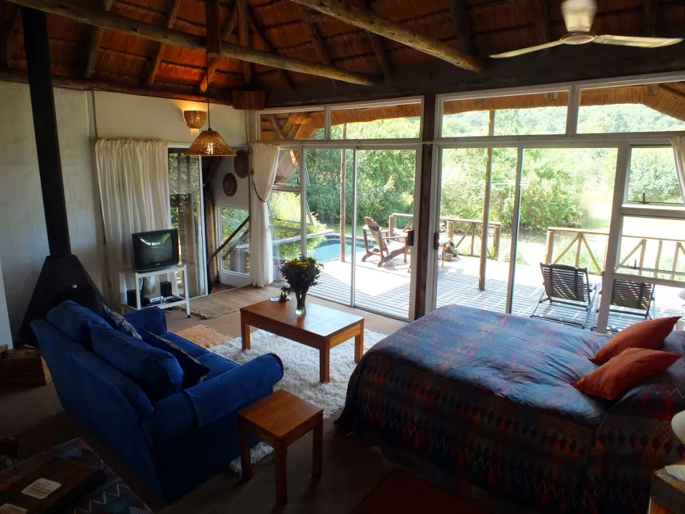 Cozy living room with a view of a patio and garden through large windows