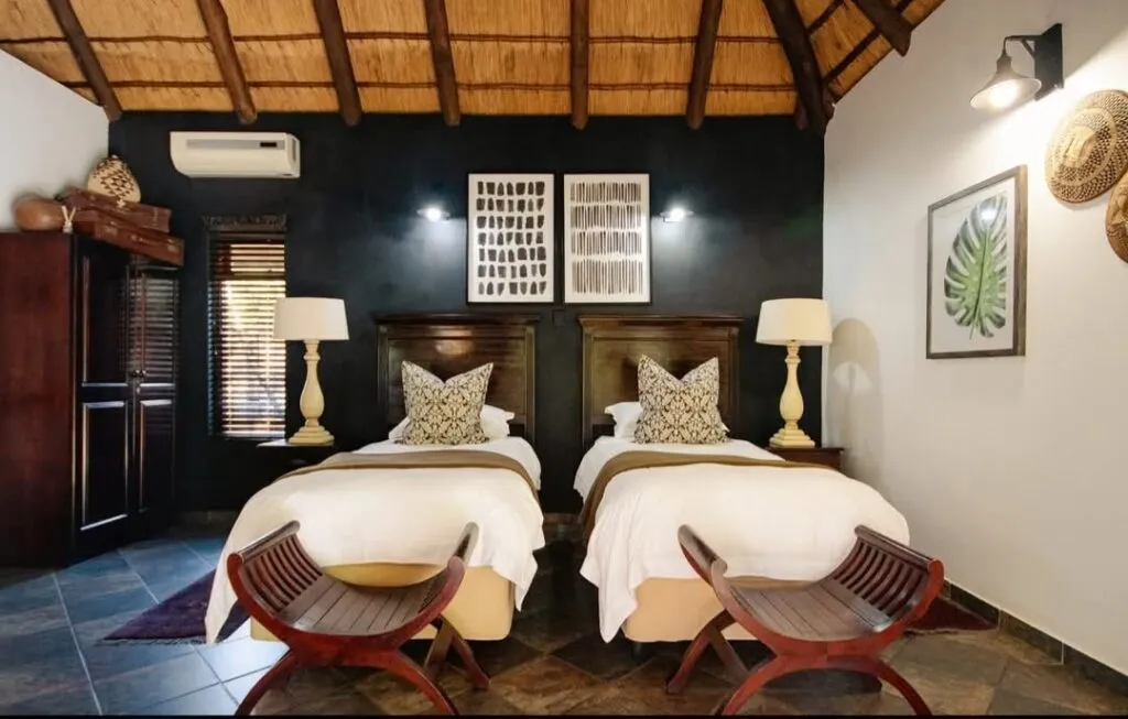 Two twin beds in a modern stylish bedroom with wooden accents and decor