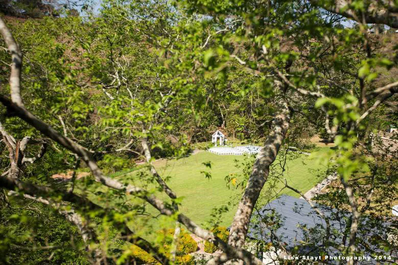 Wedding setup in a lush green garden with trees framing the view