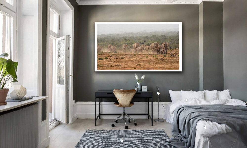 Modern bedroom with large savannah landscape artwork on the wall.