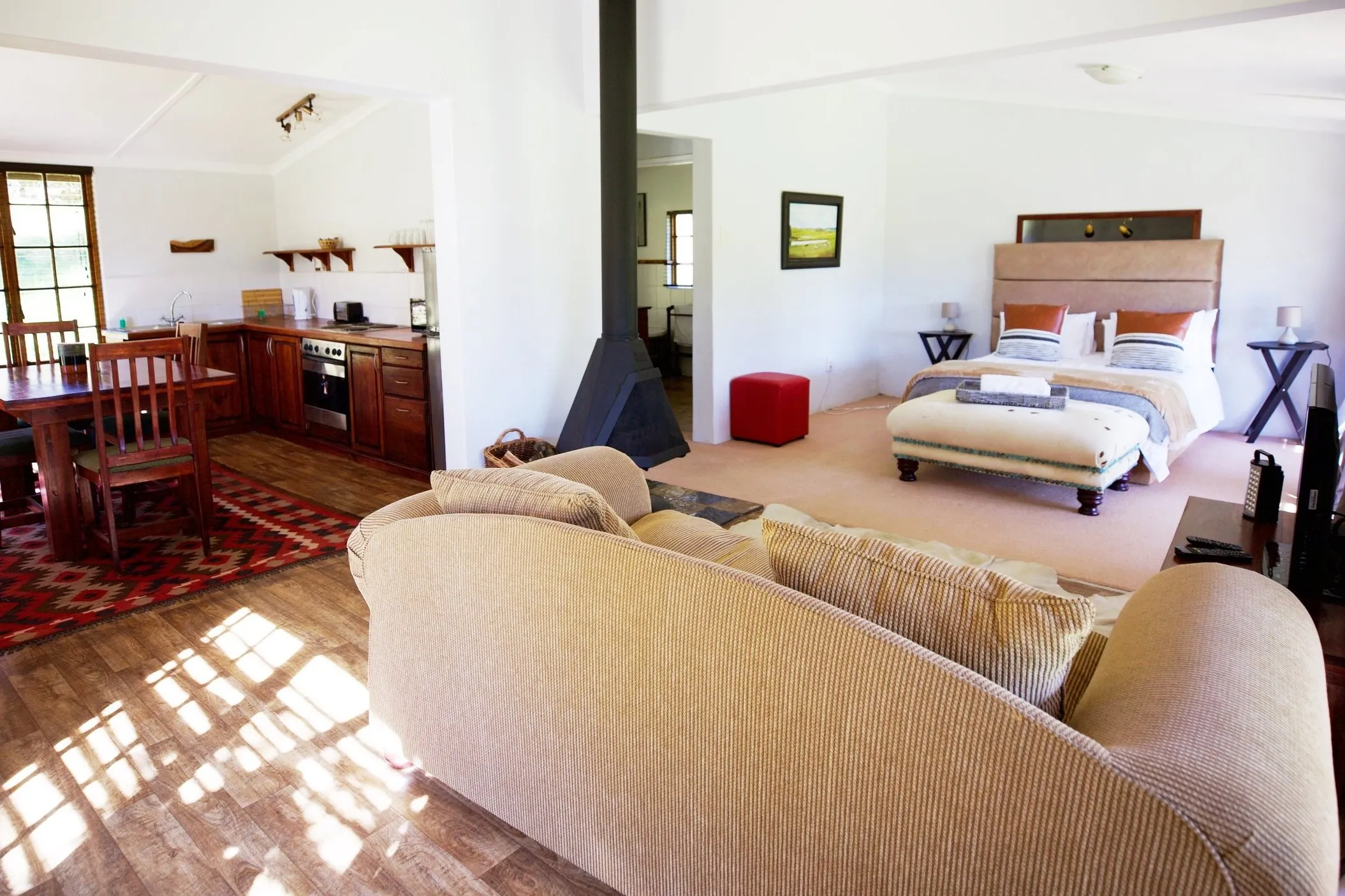 Cozy living room with sofa bed and open kitchen area