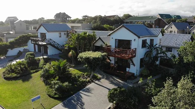 Aerial view of residential houses with gardens and driveways