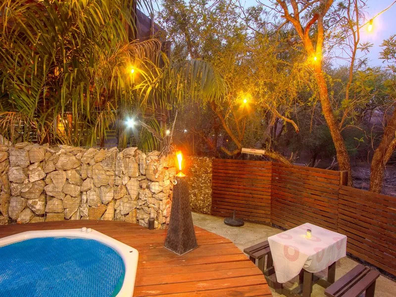 Outdoor patio with pool fire pit wooden deck and string lights