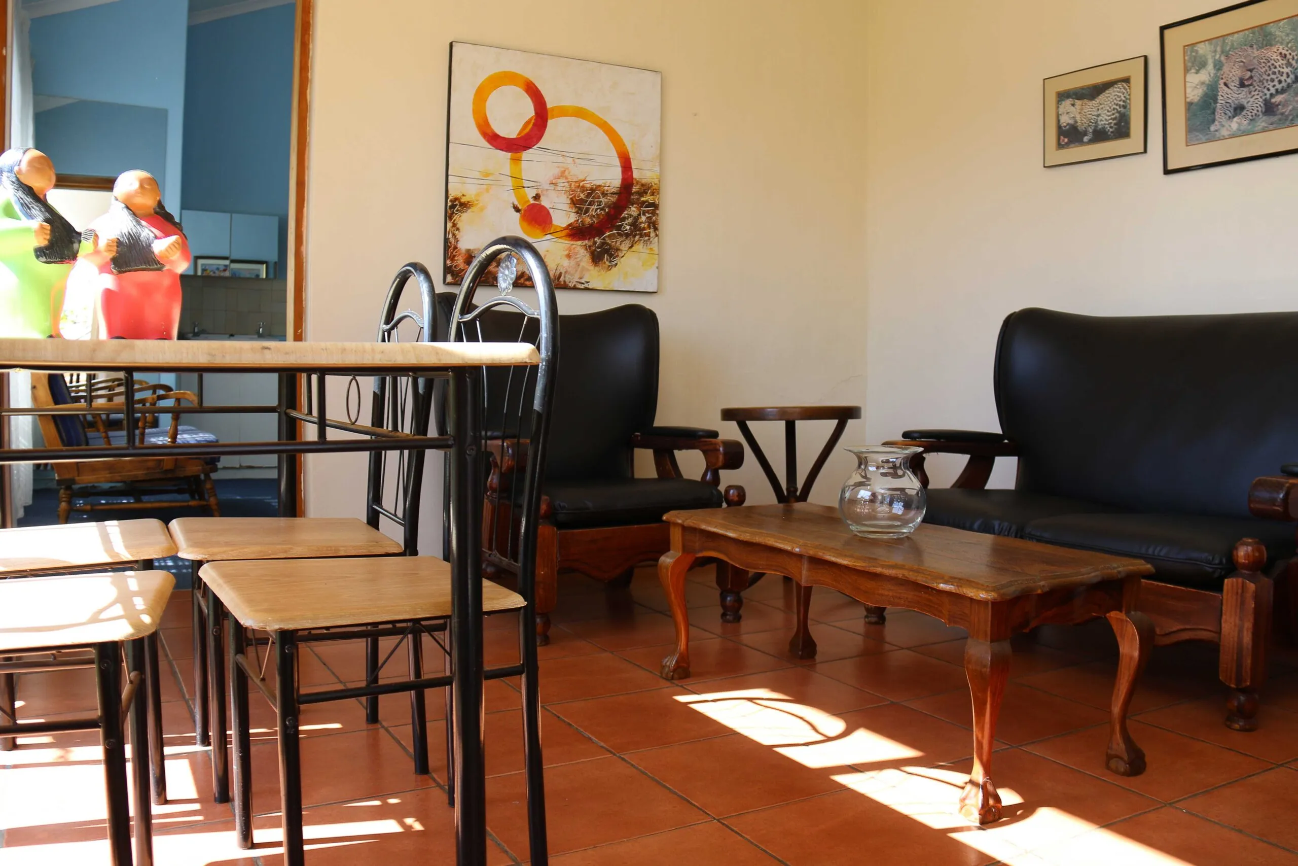 Living room with black furniture wooden coffee table and abstract wall art