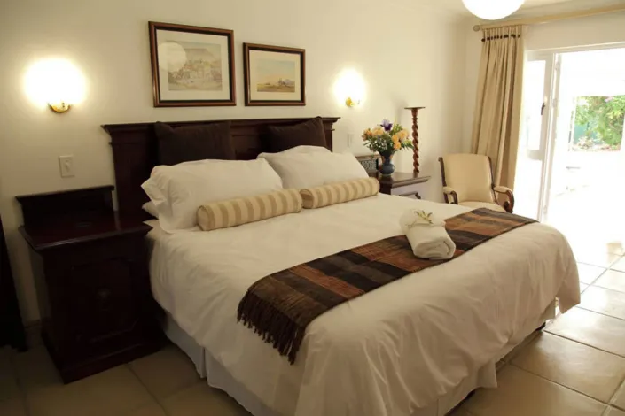 Cozy bedroom with a large bed wooden furniture and wall art