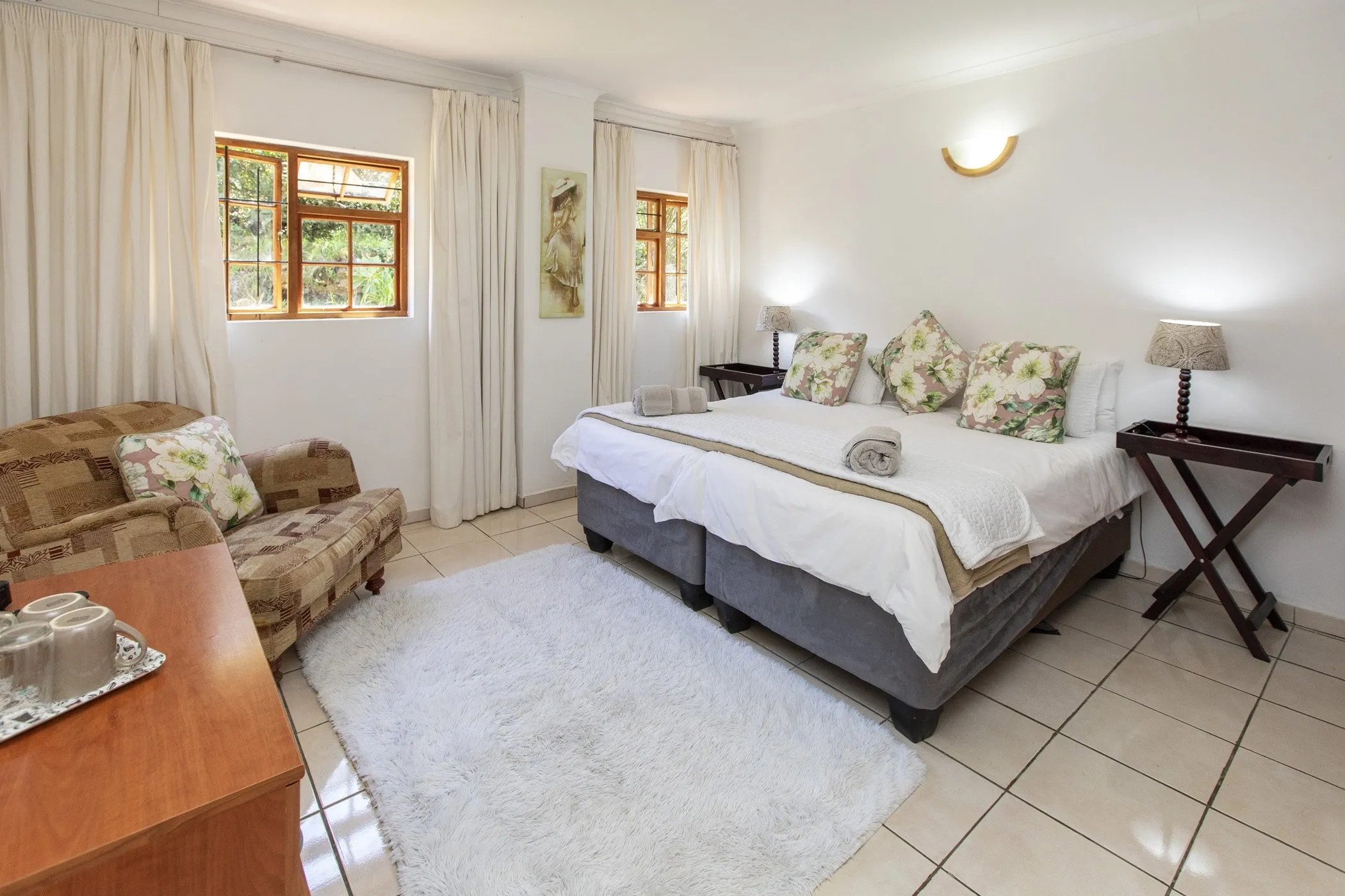 Bright bedroom with a large bed sofa and white curtains