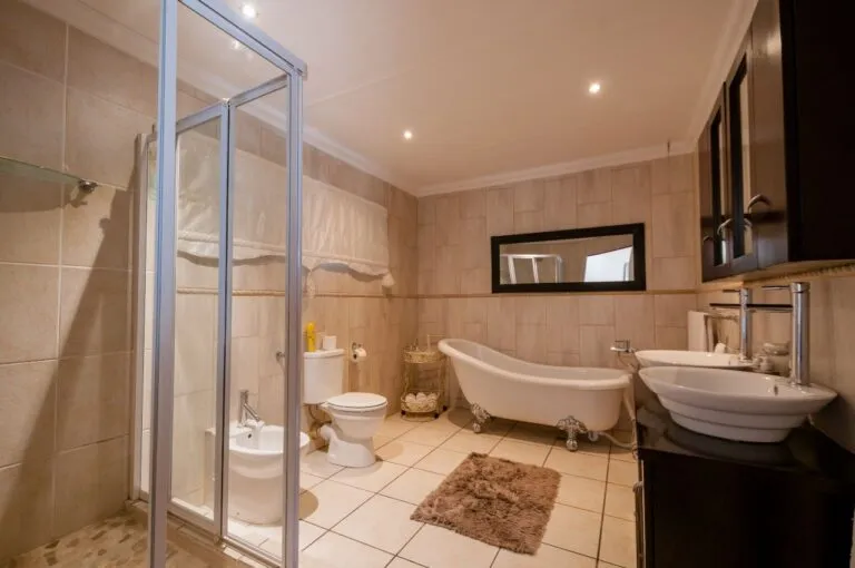 Modern bathroom with shower toilet bathtub sink and large mirror