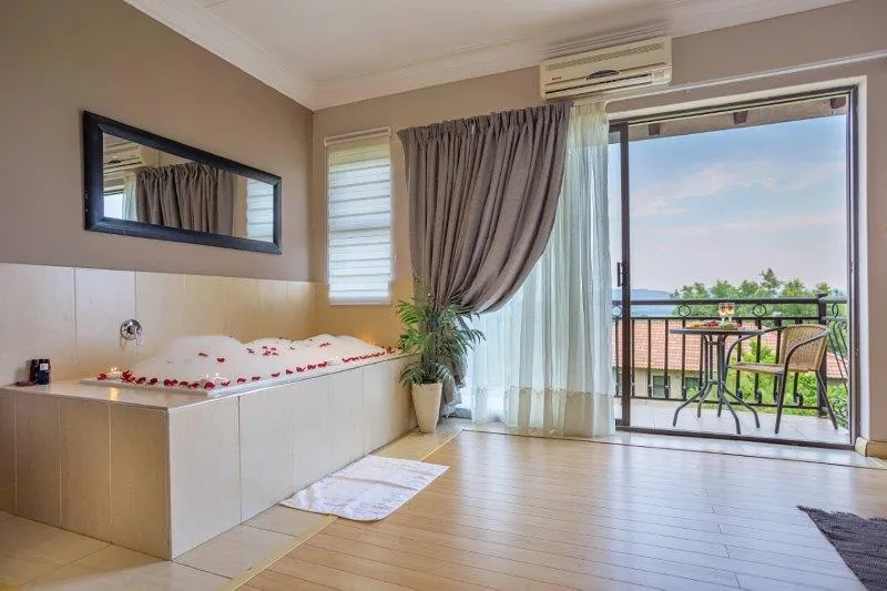 Luxury bathroom with bathtub large window and balcony view