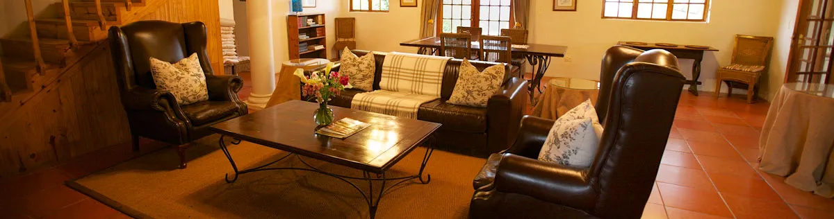 Cozy living room with brown leather chairs sofa and wooden coffee table