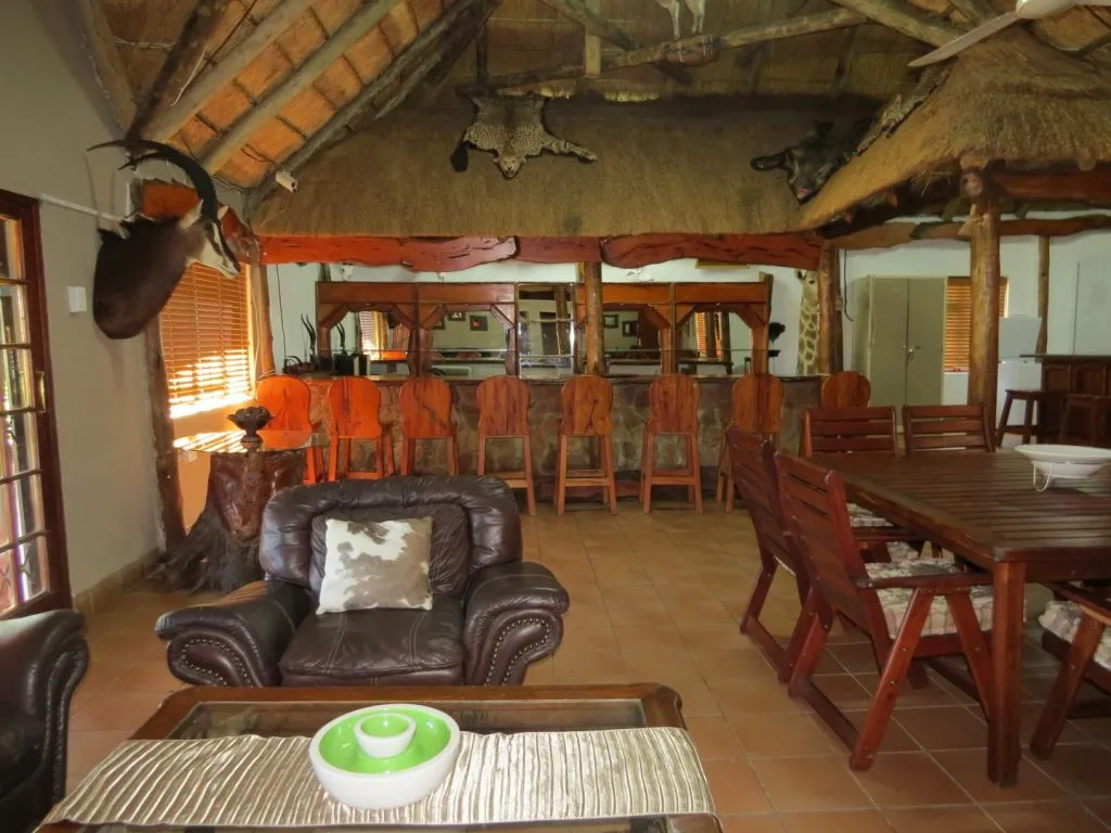 Leather chair and wooden dining area in a rustic lodge with animal decor