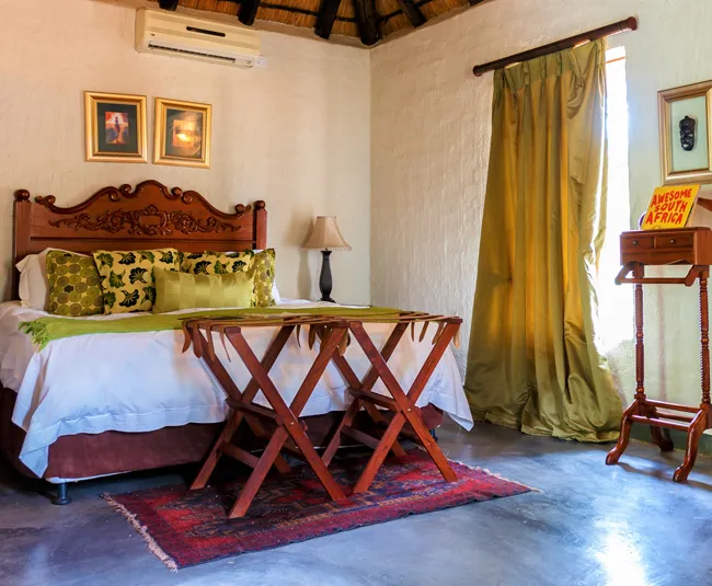 Cozy bedroom with wooden furniture green curtains and a red rug
