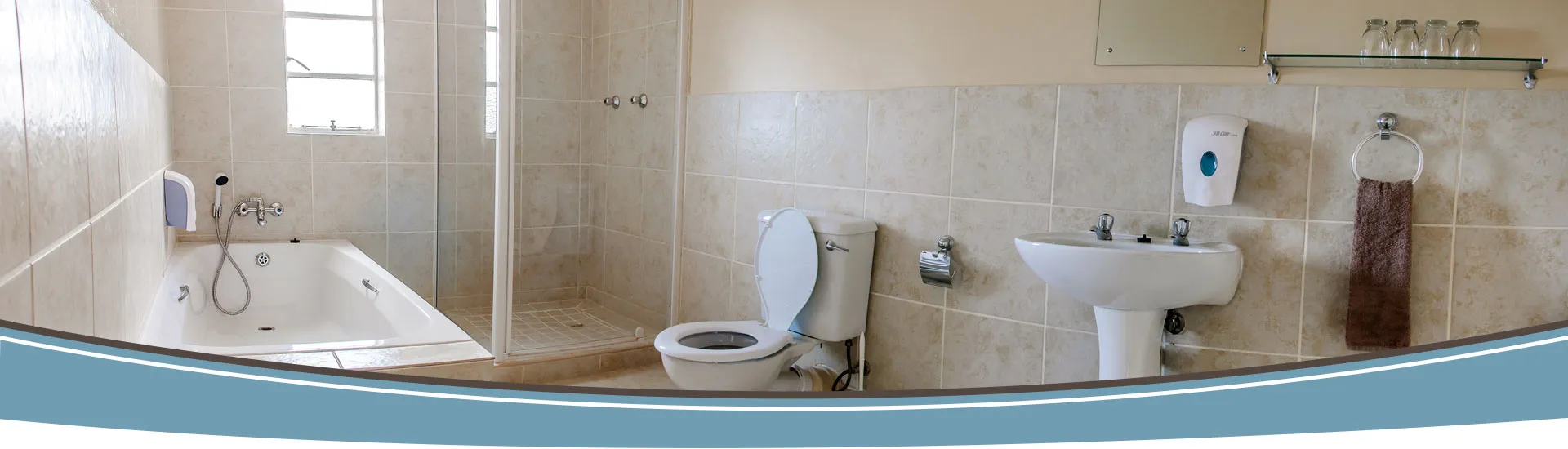 Modern bathroom with bathtub toilet sink and tiled walls