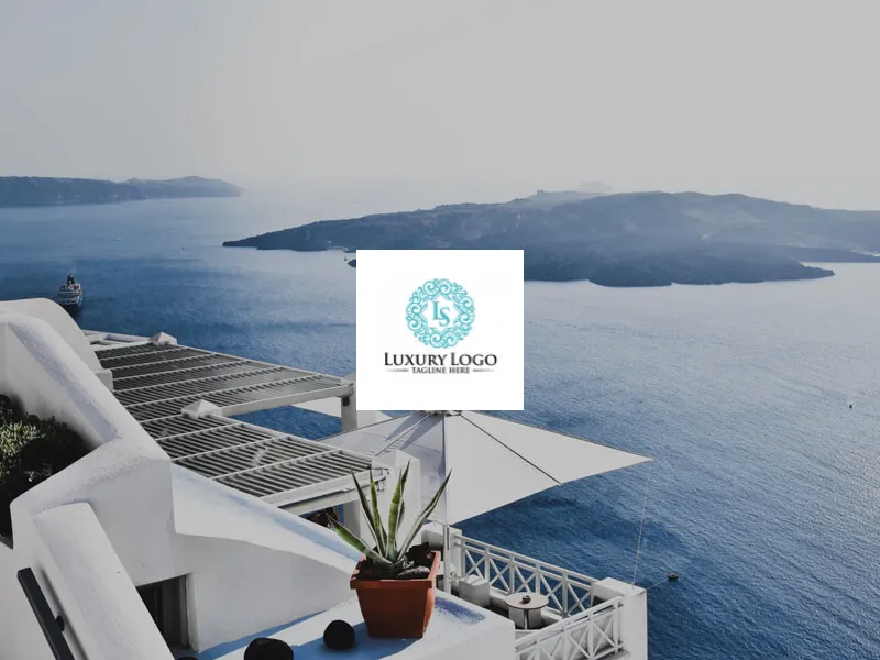 White building with logo overlooking blue sea and islands