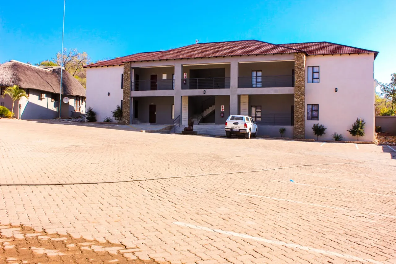 Modern twostory building with a tiled roof and open paved courtyard