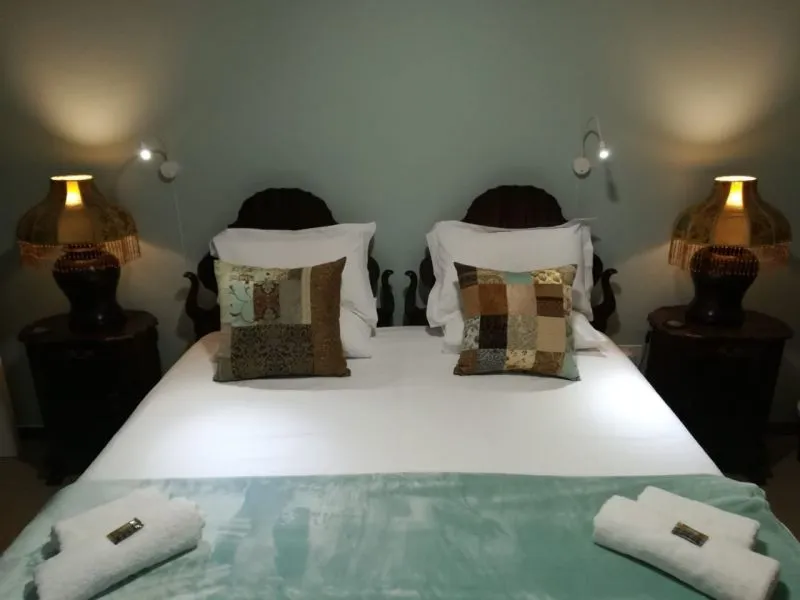 A neatly made bed with two bedside lamps in a cozy bedroom