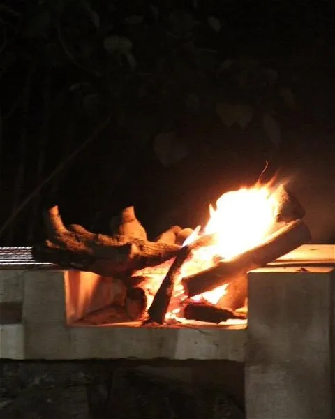 Fire burning in a stone fireplace at night