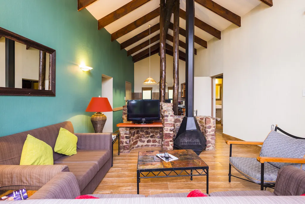 Cozy living room with fireplace TV and modern furniture in a cabin