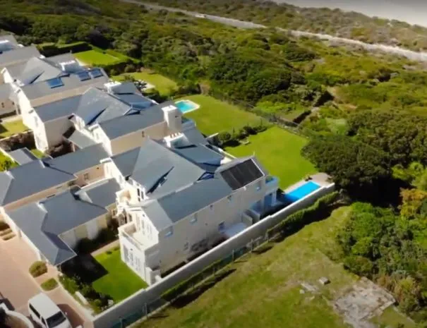 Aerial view of large house with pool and surrounding greenery