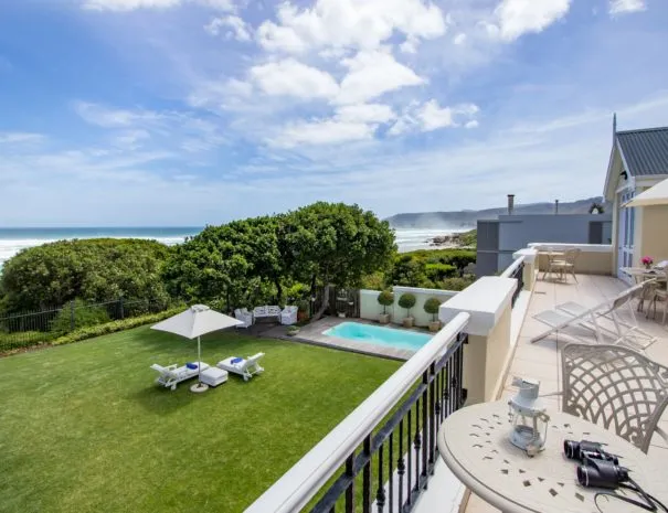 Ocean view from balcony with pool garden and lounge chairs
