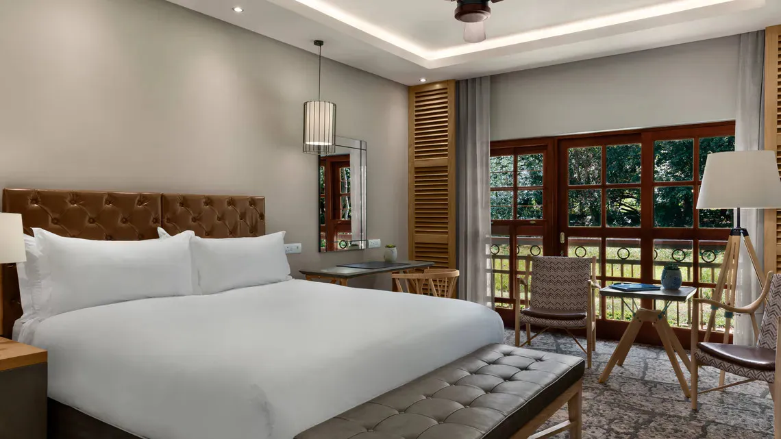 Modern hotel room with large bed seating area and large windows