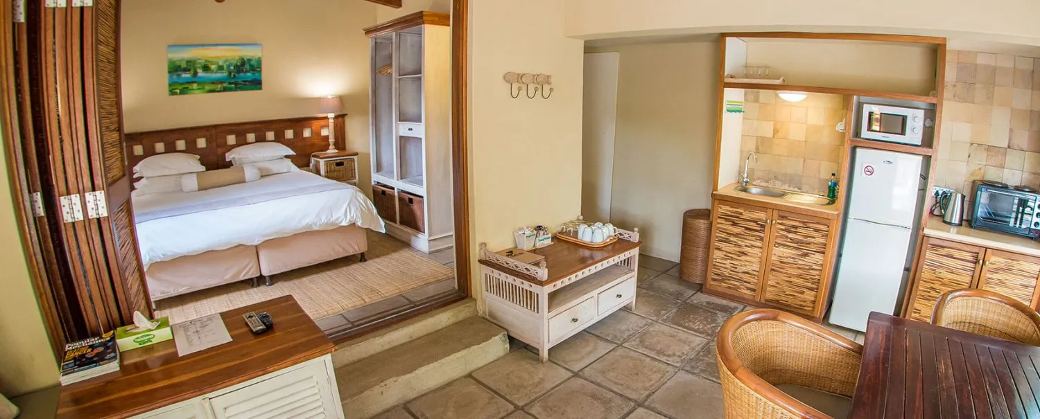 Cozy studio apartment with bed kitchenette and dining area