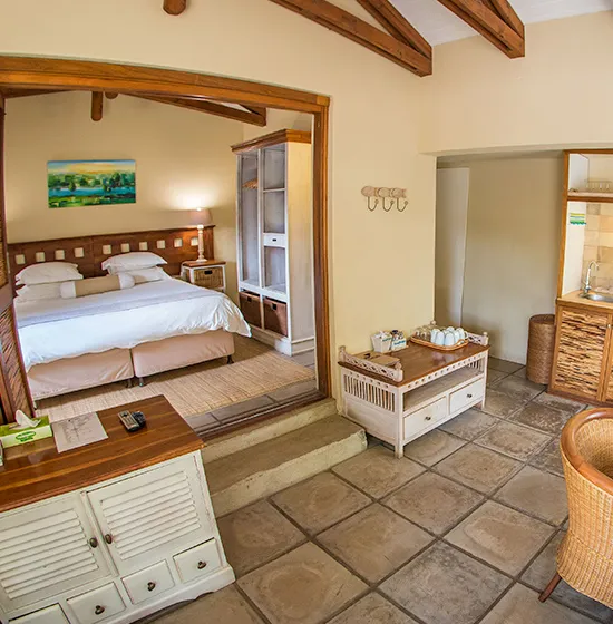 Cozy bedroom with wooden furniture tiled floor and a small bathroom area