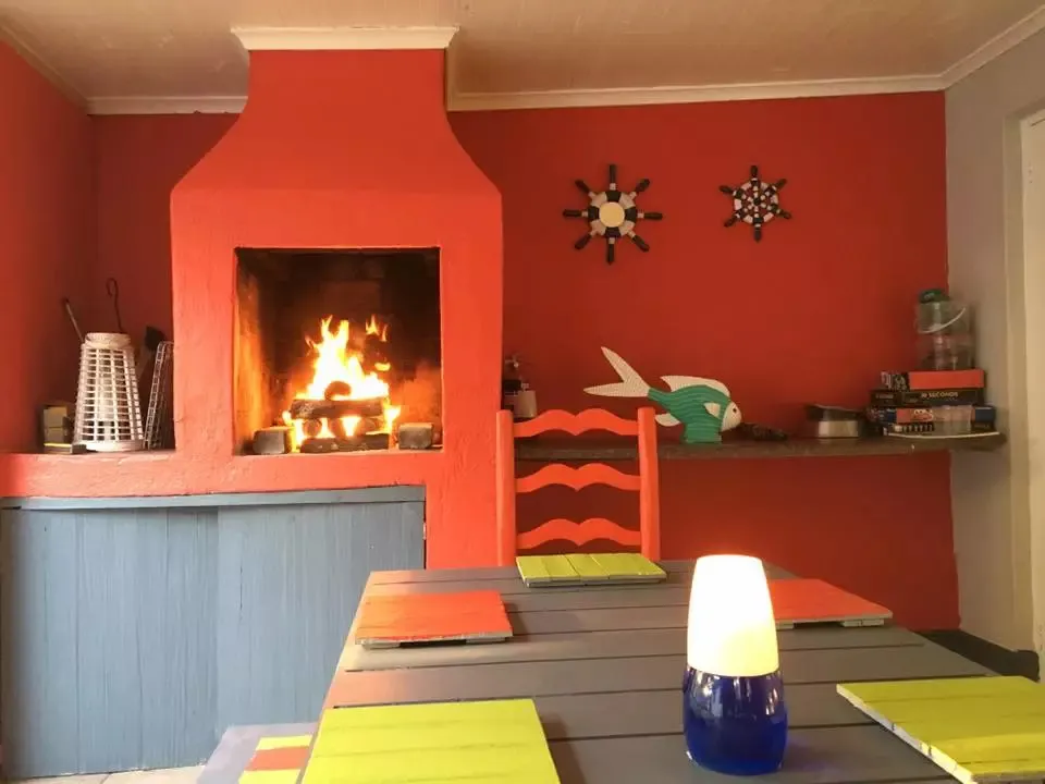 Cozy kitchen with a lit fireplace colorful decor and a dining table