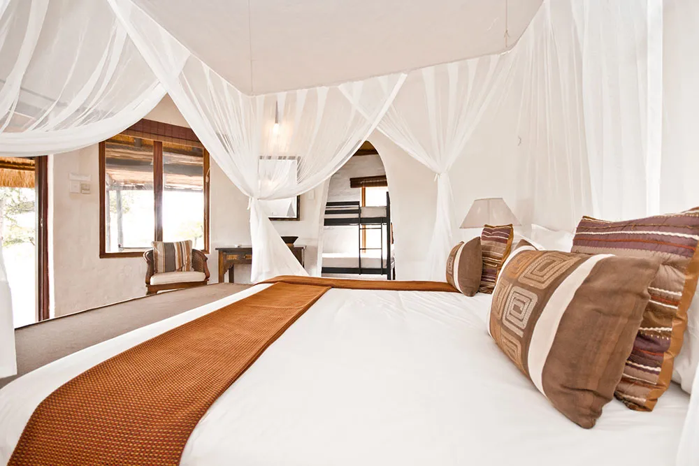 Bedroom with a large bed canopy and a view of a patio outside
