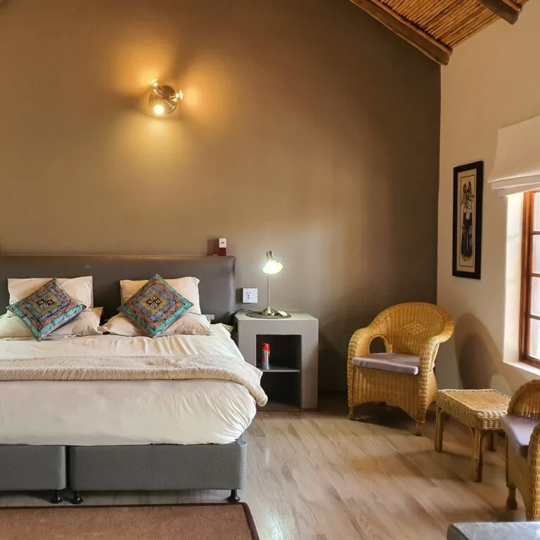 Cozy bedroom with a double bed armchair and wooden floor