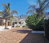 Courtyard with palm trees brick paving and mountains in the background