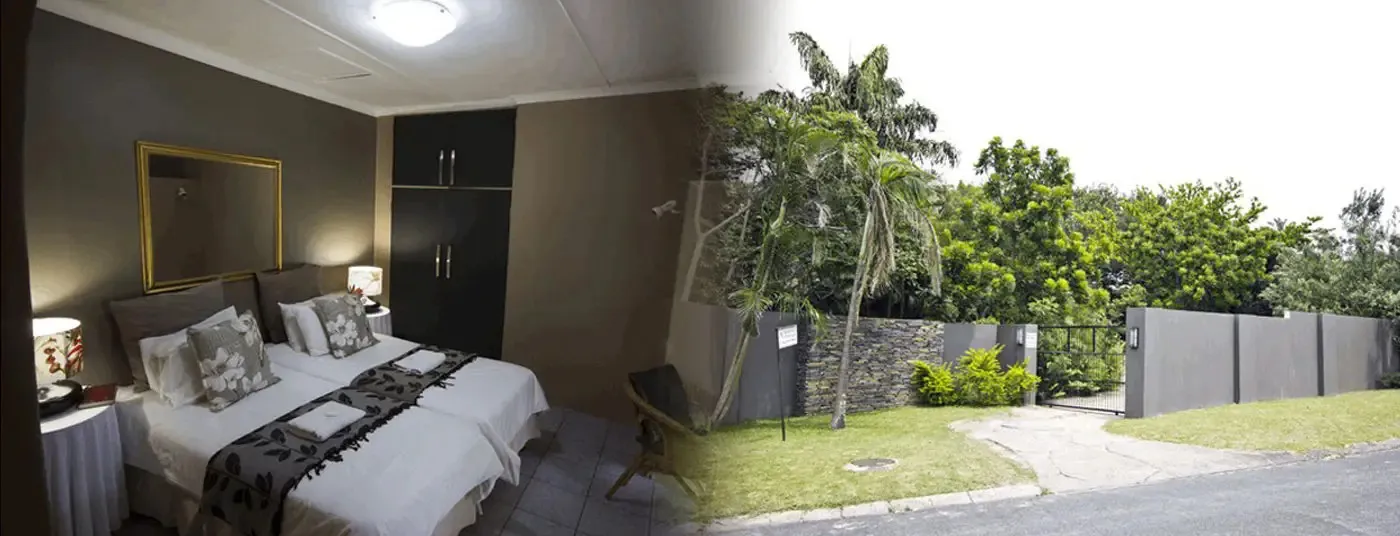 Bedroom with double bed and exterior view of house with greenery and driveway