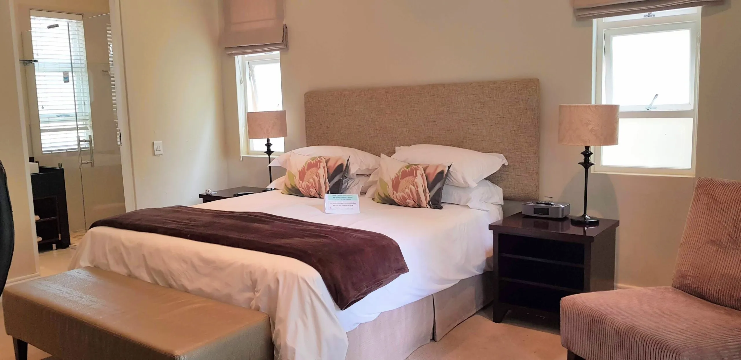 Cozy bedroom with a large bed two nightstands and a bench