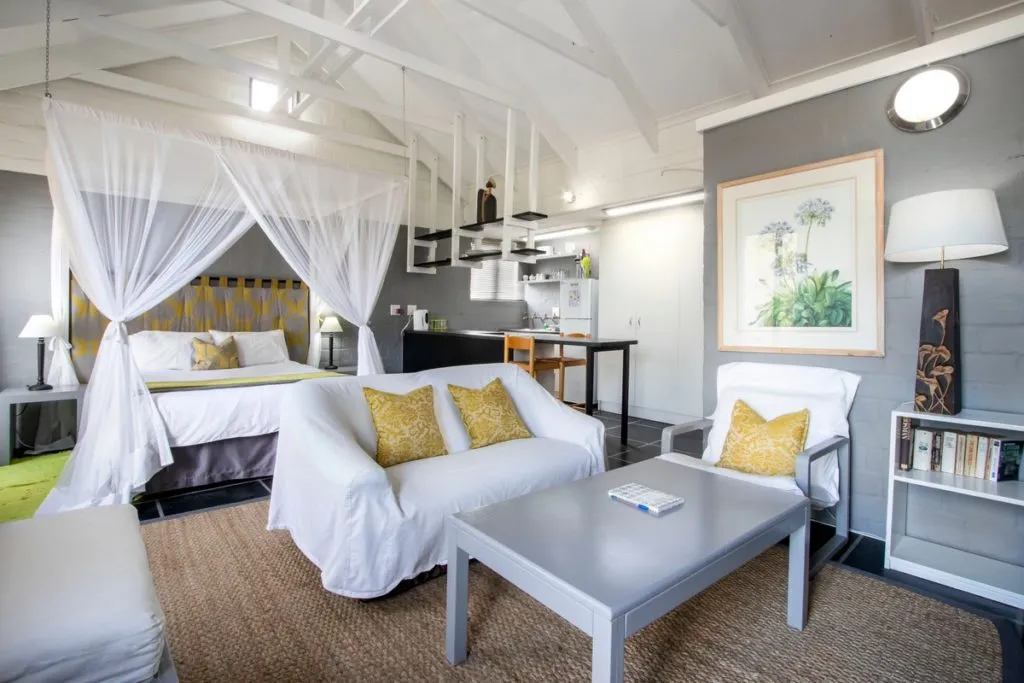 Cozy studio apartment with bed sofa coffee table and kitchenette