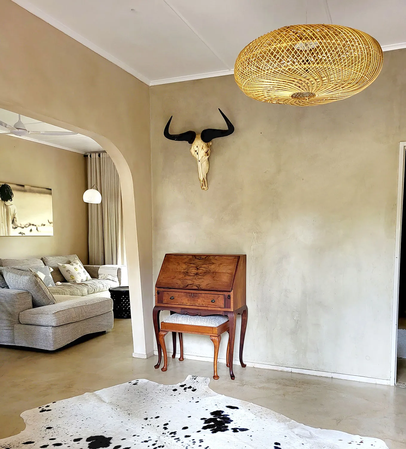 Living room with cow skull on wall wooden desk and cowhide rug