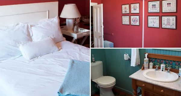 Bedroom with white bed red walls and adjacent bathroom with toilet and sink