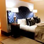 Elegant bedroom with a large bed dark headboard and bedside lamps