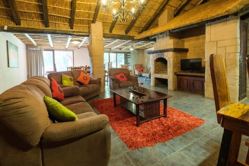 Cozy living room with sofas coffee table and fireplace in a rustic setting